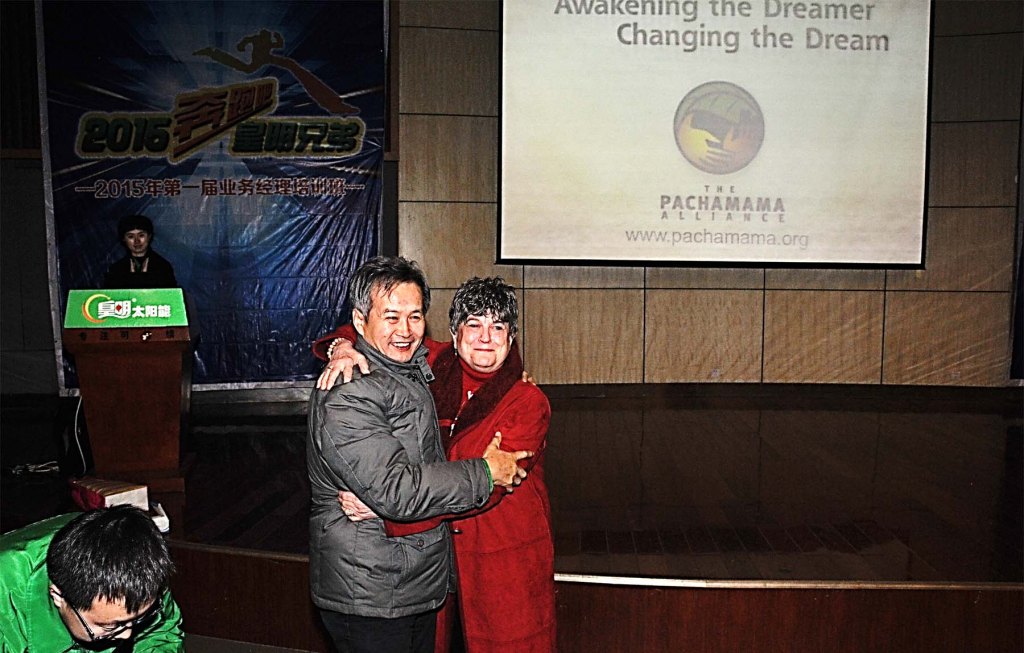 Mary and Huang Ming in front of ATD Logo on Screen