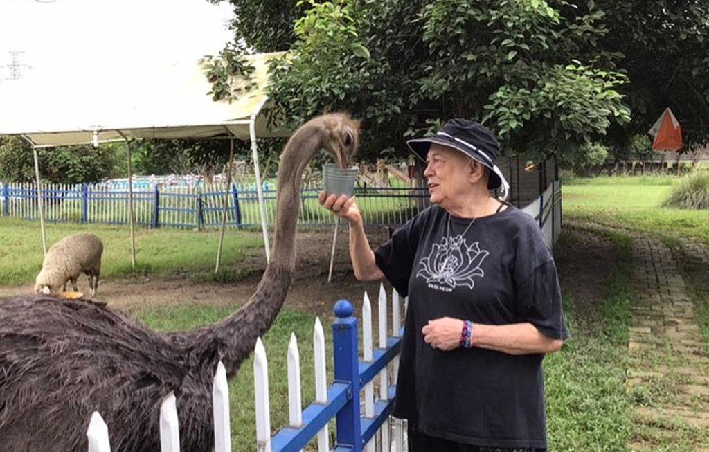 Mary feeding an ostrich.