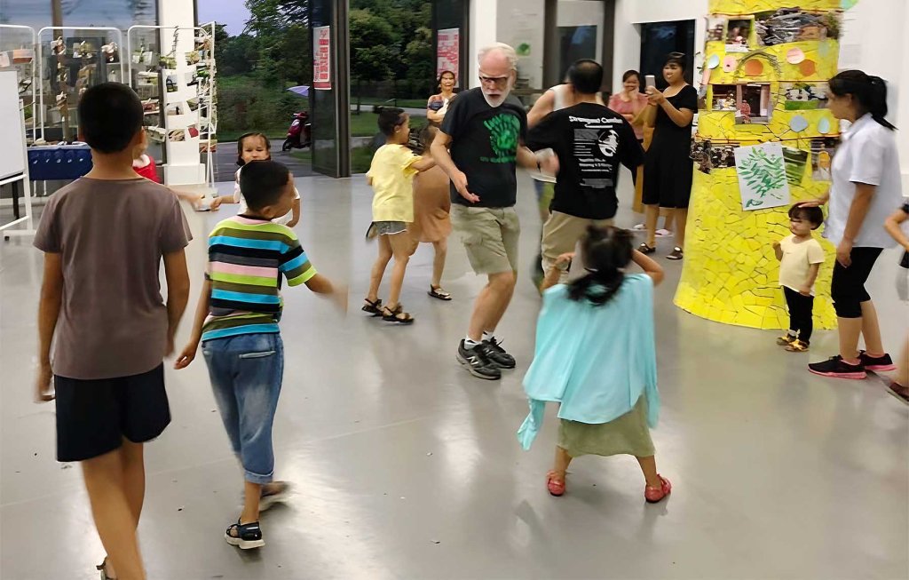 Sully dancing with children in China